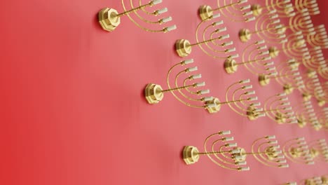 golden menorahs on a vibrant red background vertical