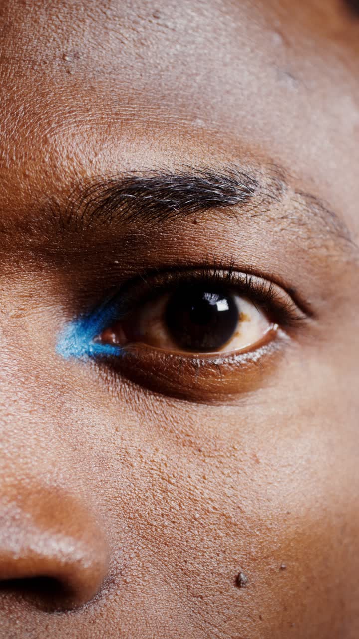 Close-up of a woman's eye with blue eyeliner