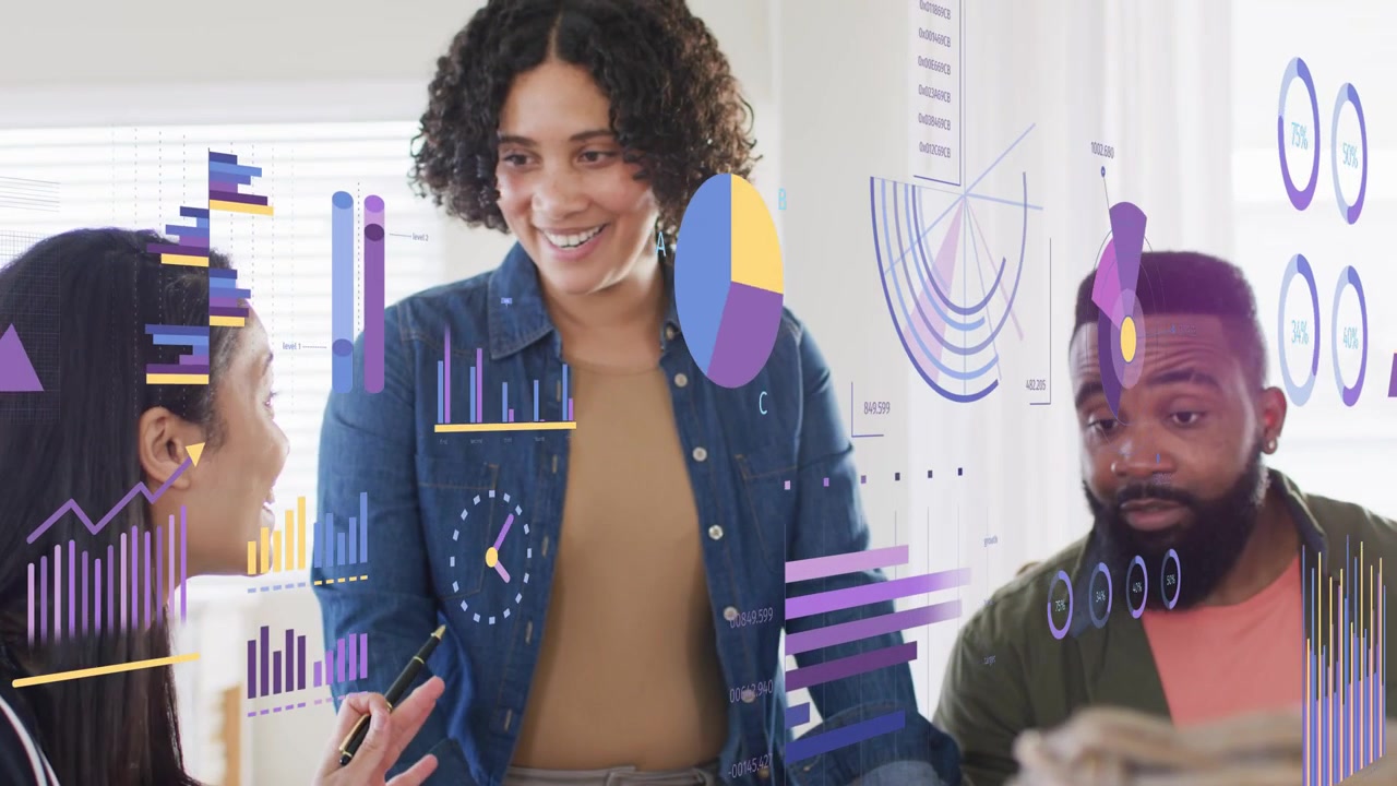 Seated woman pointing at tablet and causing animated charts to appear, team reviewing analytics