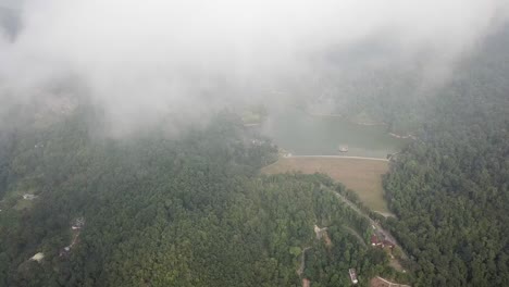 Aerial-view-of-a-foggy-morning-over-dam-Ayer-Itam,-Penang.