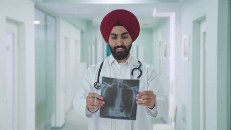 happy sikh indian doctor checking x ray report