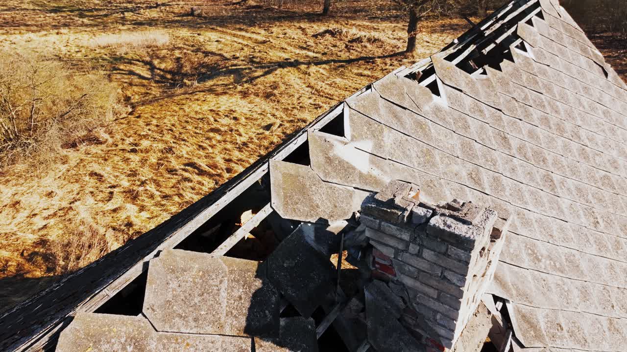 Spring light, structural collapse, rural Soviet building during reverse flyover