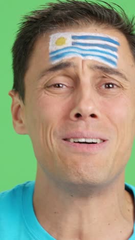 very nervous man supporting uruguayan team during a difficult match