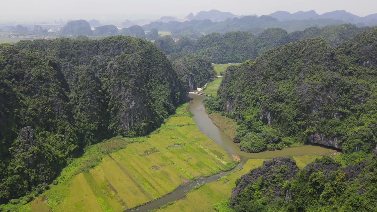 Stunning Aerial View of Lush Green Rice Paddies and Karst Mountains in Vietnam