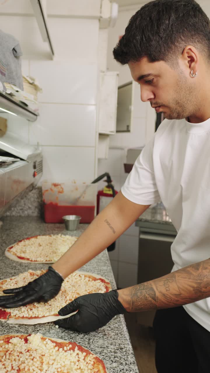 Chef Preparing Pizzas in a Restaurant Kitchen
