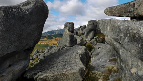 close up shot of famous rock formation landmark at castle hill and beautiful rural landscape with mountains in backdrop