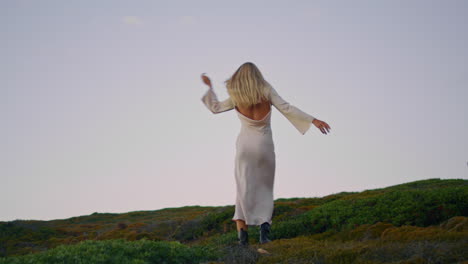 sensual woman spinning tower landscape. carefree girl enjoying lighthouse nature