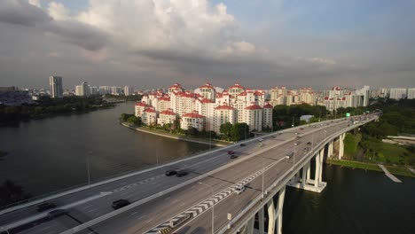 Aerial-shot-in-Singapore-showing-apartments-in-background-with-traffic-moving-along-a-viaduct-highway