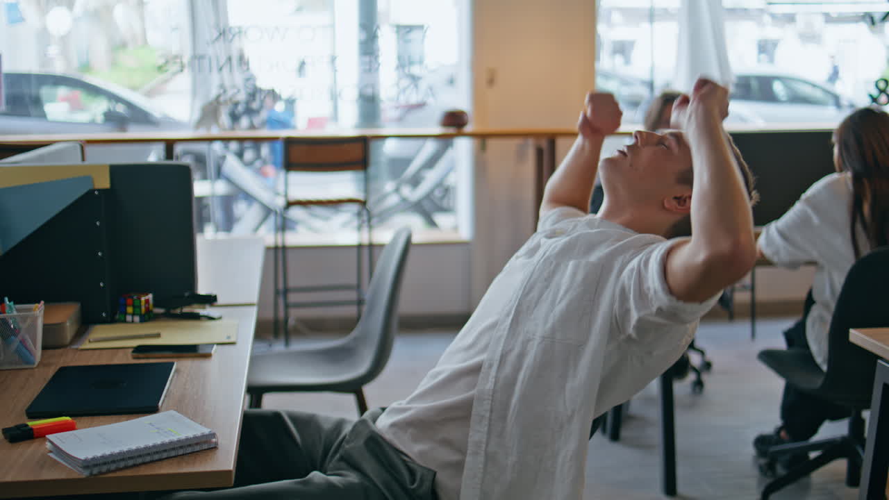 Inspired man texting computer at workplace closeup. Programmer closed laptop lid