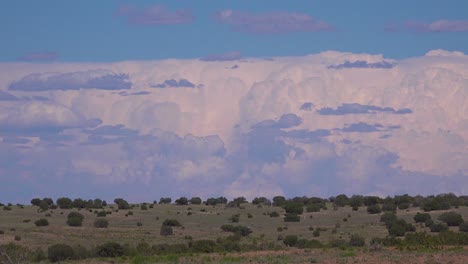 beautiful walls of thunderheads and storm clouds move across the new mexico desert