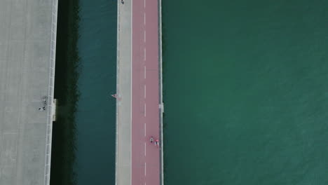 aerial top down road bridge crossing the ocean water connecting city urban infrastructure