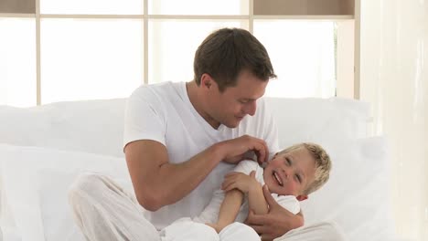 close up of father and son in bed