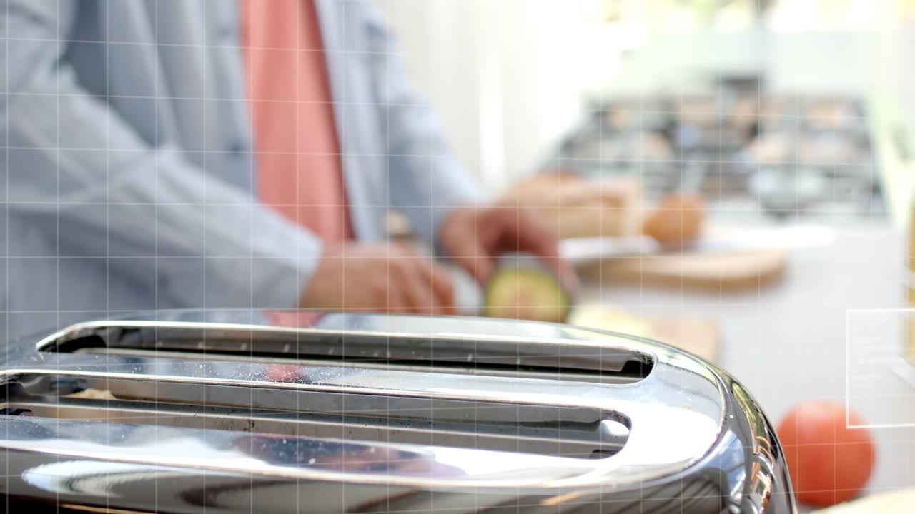 Mid adult man placing bread into shiny toaster during breakfast, overlay graphics showing progress