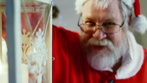 Portrait-of-santa-claus-holding-lantern