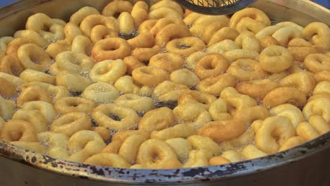 street vendor cooks and sells hot oil dough