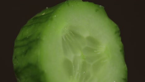 rotate of cucumber piece on a dark background