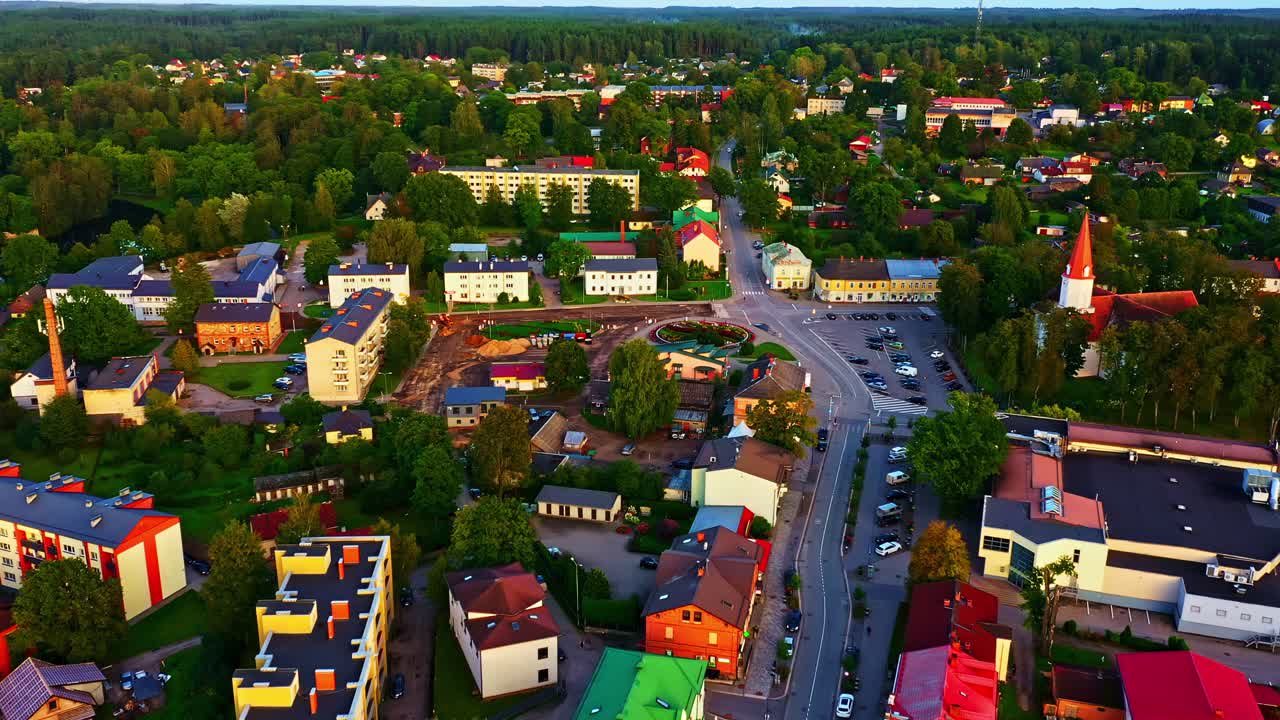 Colorful central area of Smiltene with church, rooftops, and winding streets