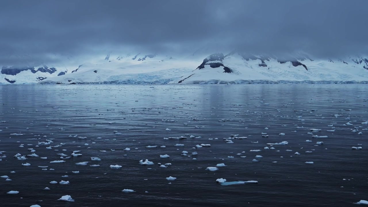 Global Warming and Climate Change with Melting Ice and Warming Ocean in Antarctica, Mountains and Winter Scenery on Antarctic Peninsula in Beautiful Dramatic Coastal Scene
