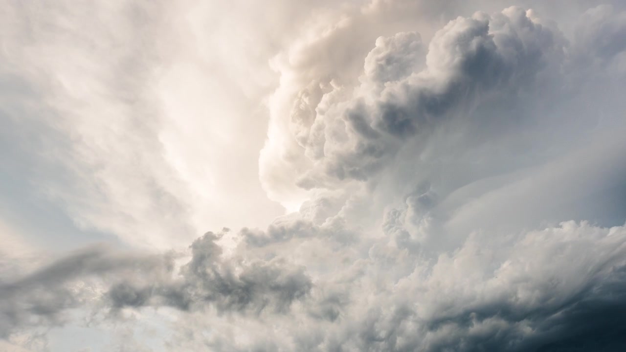 Dark thunderclouds rolling through sky in dramatic storm scene background
