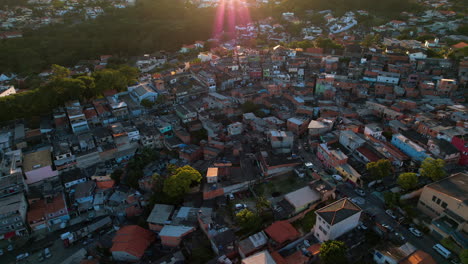 aerial overview of poverty community, sunny evening in south america - circling, drone shot