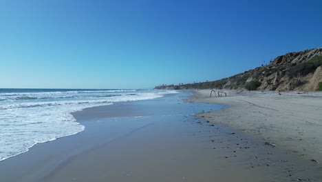 drone flight over ocean waves on a beautiful sunny day in carlsbad california