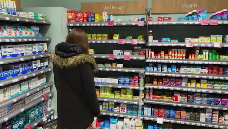 a woman in the health and well being section of a supermarket in oundle northamptonshire.
