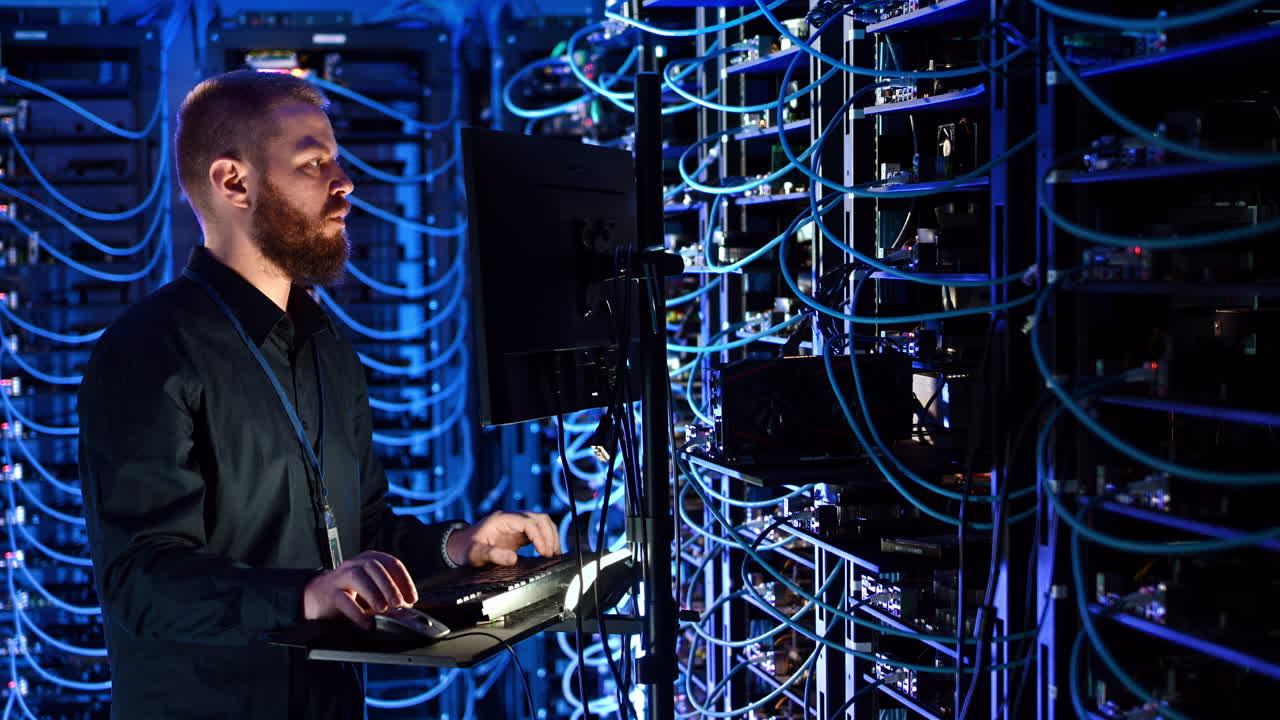 Man programming in a server room