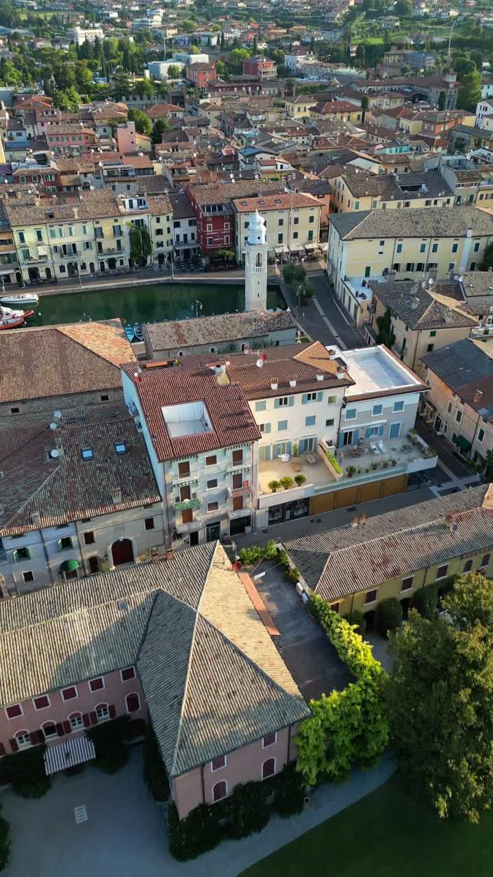Historical old town of medieval Lazise Italy roman times architecture, aerial drone vertical video