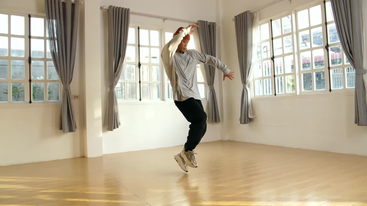 Young Male Breakdancer Dancing In Studio, Slow Motion