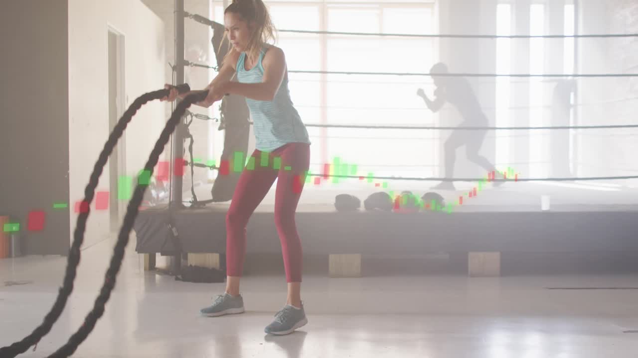 Woman gripping ropes, creating alternating waves for fitness, green red data bar moving with ropes