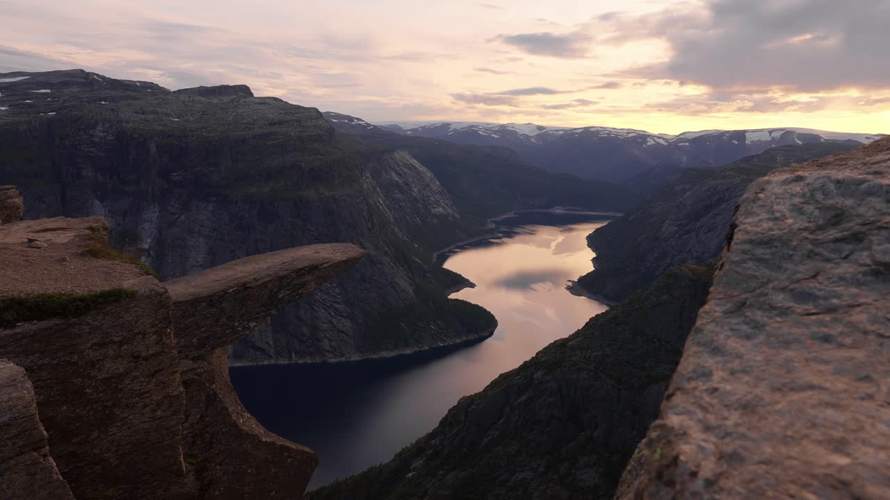 Dramatic cliff view at sunset over fjord in Norway, peaceful and majestic vibe, Trolltunga
