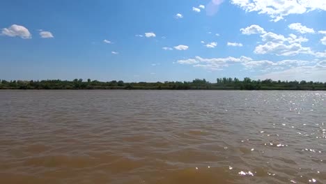 SLOW-MOTION---Muddy-water-in-a-lake-on-a-sunny-day-in-Alberta-Canada