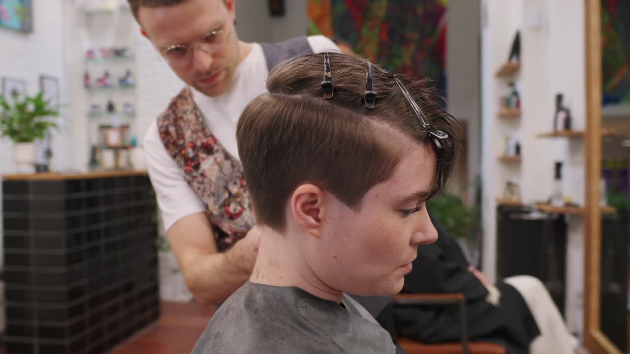 Hairdresser giving a haircut