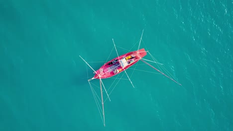 aerial view drone tracking a tourist thai longtail fishing boat in phuket islands,amazing andaman sea in phuket thailand on a sunny morning with beautiful sea background
