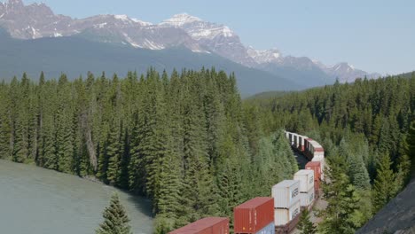 long wagon freight cargo container train in banff national park, canada