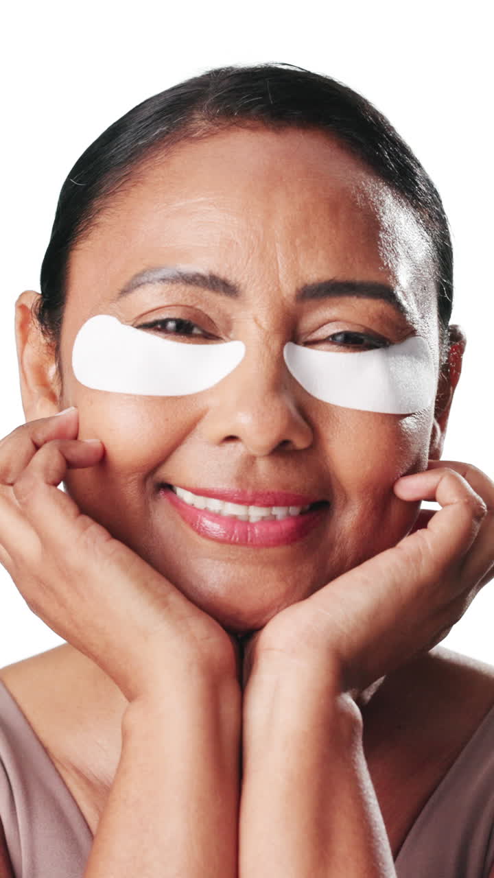 Happy Mature Woman with Under-Eye Patches Smiling at Camera