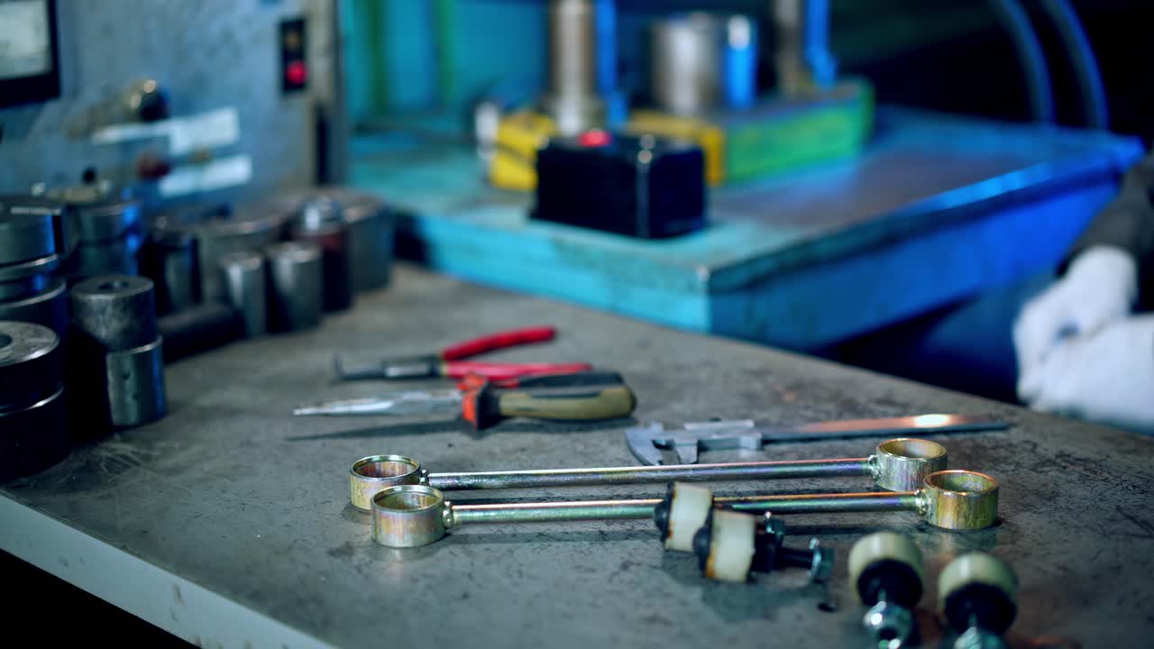 Metal Formation by Hydraulic Press. Worker at manufacture workshop operating metal press machine