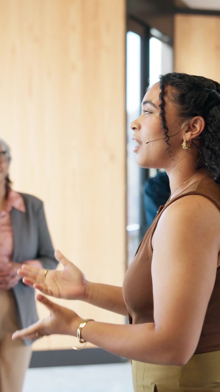 Young Woman Giving a Presentation to Colleagues in an Office