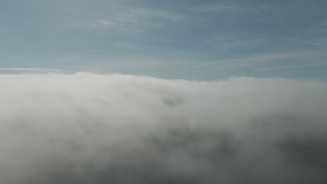 Drone-view-above-thick-gray-clouds-above-Magdalen-Islands-in-Quebec