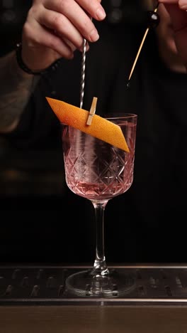 a bartender preparing a grapefruit cocktail