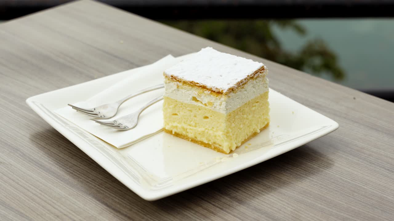 Closeup arcing view of zesty Bled Cream Cake (Kremšnita) at Kavarna Park Café