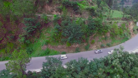 aerial view of a curved winding roads trough the forest at mountain, beautiful nature and transportation from panoramic view