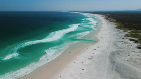 aerial view flying over a long, quiet paradise beach, cloudy day in brazil