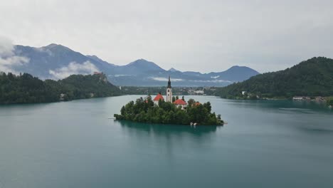 orbit drone shot of lake bled, slovenia in the morning during summer time