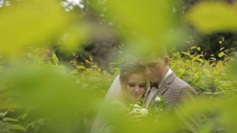 Newlyweds.-Caucasian-groom-with-bride-walking,-embracing,-hugs-in-park.-Wedding-couple