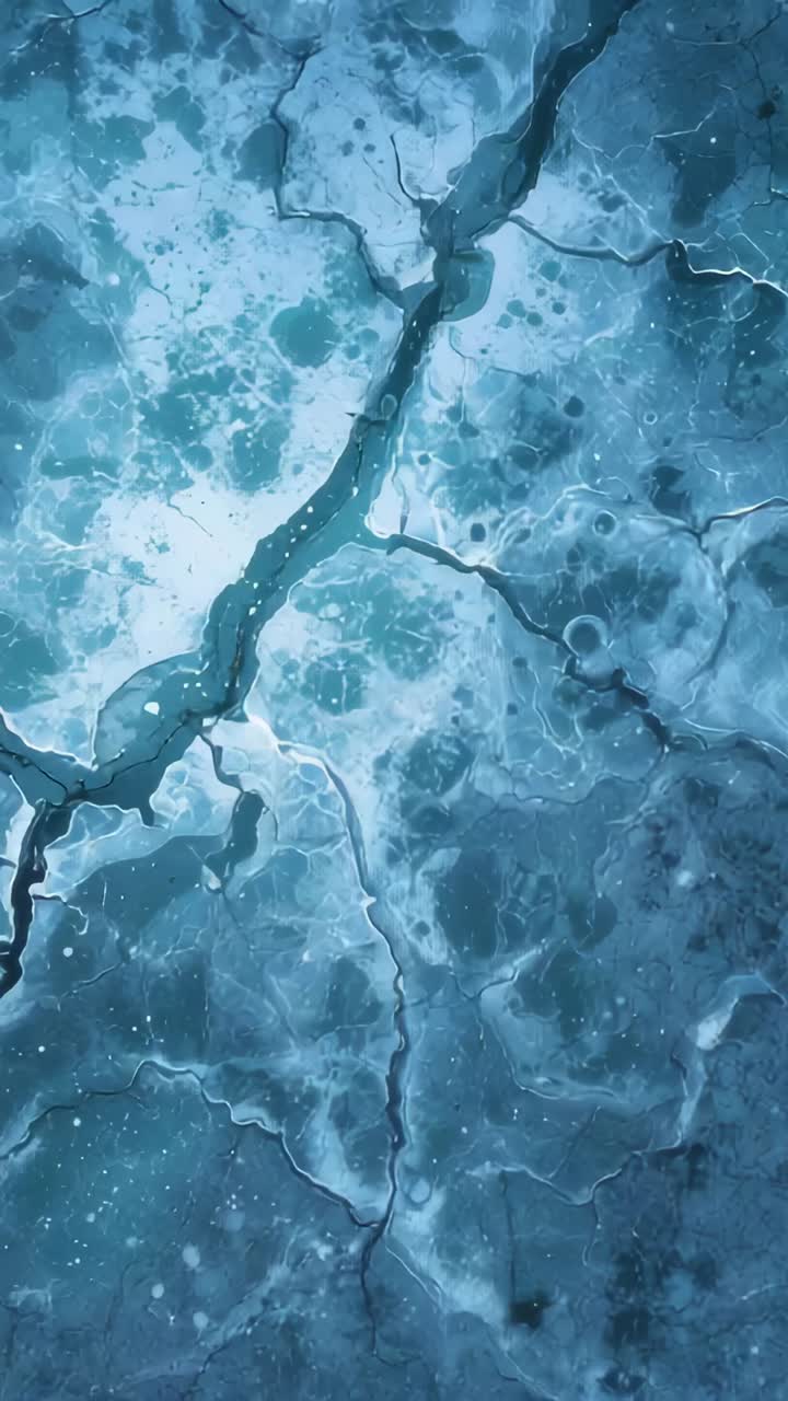 Vertical video: Camera drifting down exposing frozen surface overhead to reveal fissure and specks