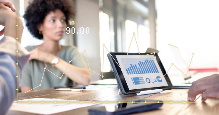 Woman studying tablet as colleague tapping screen triggers animated graph showing business trend