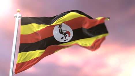 bandera de uganda ondeando en el viento en lento al atardecer, bucle