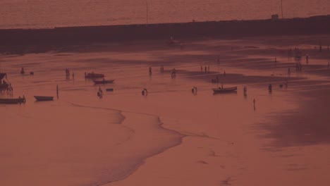 fishermen working at beachside fishing harbor