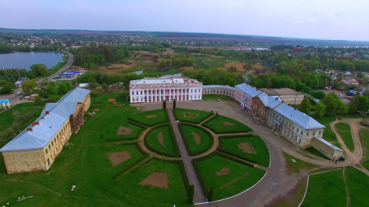 Palace of three parts situated on the river bank. Drone footage approaching the museum. Scenery of town at backdrop.
